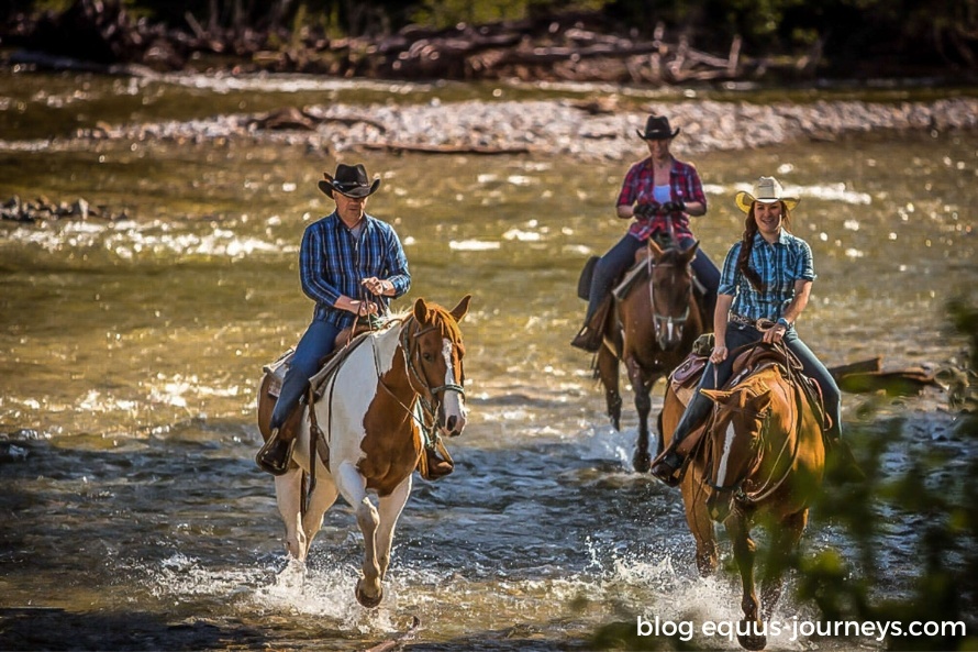 Riders and horses riding out of a guest ranch in Canada