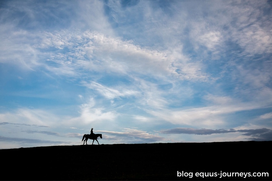 Woman riding in the mountains