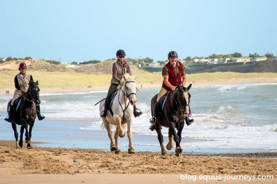 Riders cantering on Brittas Bay